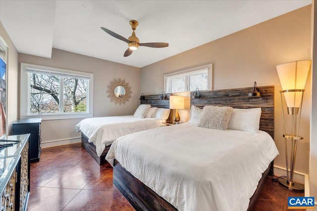 tiled bedroom featuring multiple windows and ceiling fan