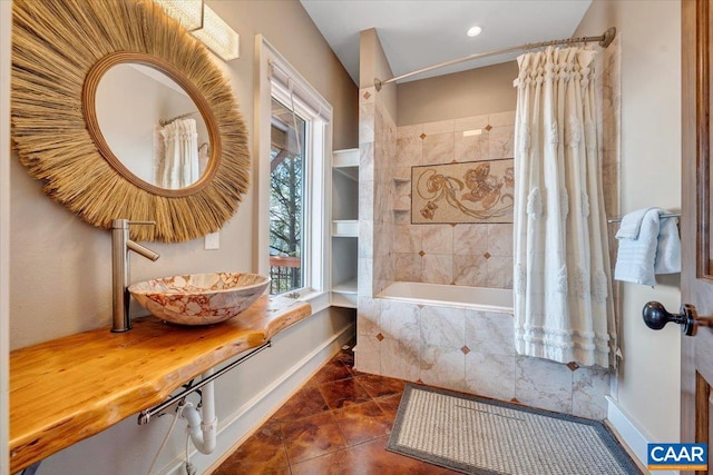 bathroom with tile patterned floors, sink, and shower / bath combination with curtain