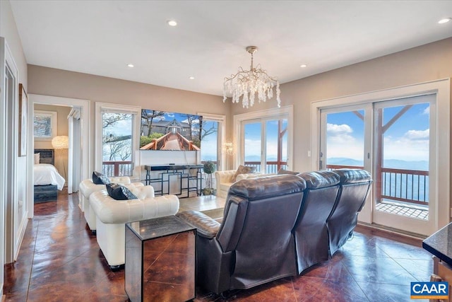 living room with an inviting chandelier and plenty of natural light