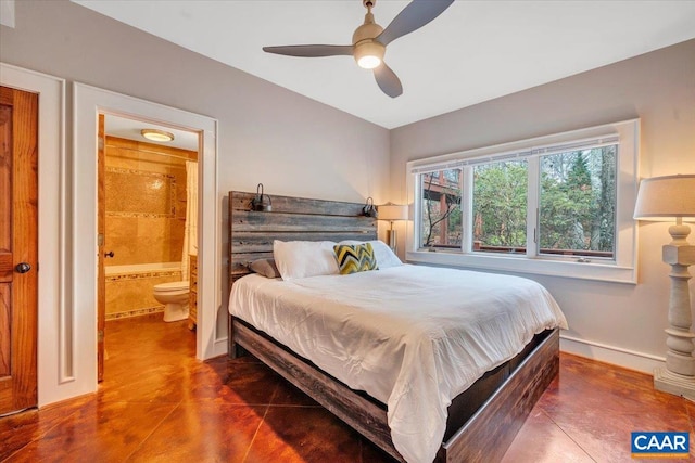 bedroom with dark tile patterned floors, ceiling fan, and ensuite bathroom