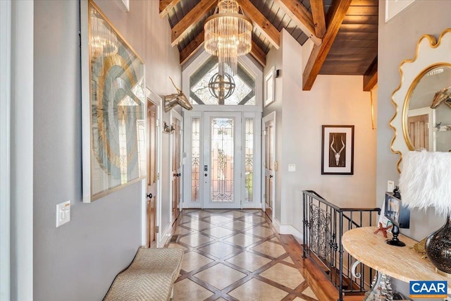 entrance foyer with high vaulted ceiling, beamed ceiling, a chandelier, and wood ceiling