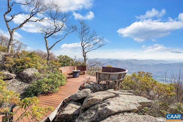 wooden deck with a mountain view