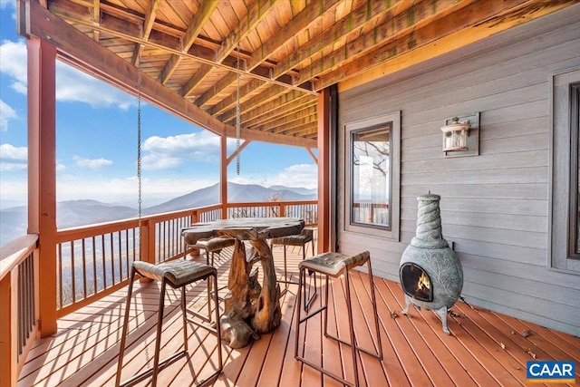 wooden deck with a mountain view