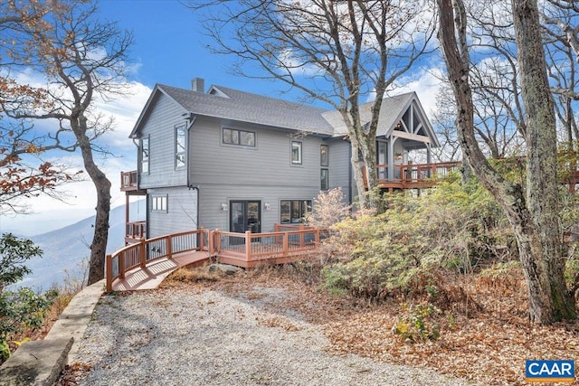 back of house featuring a deck with mountain view