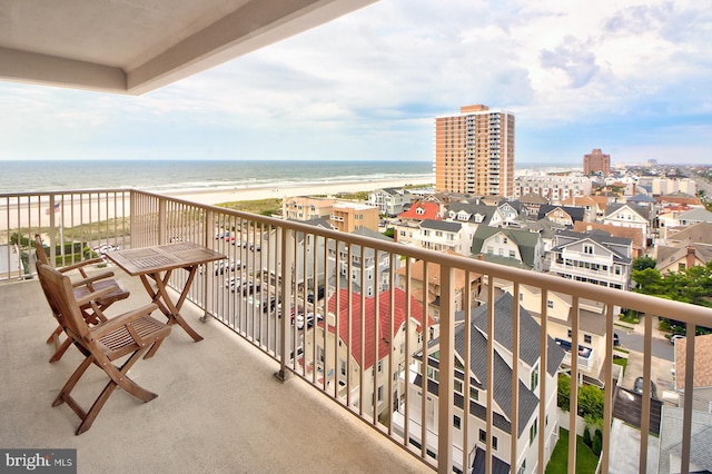 balcony featuring a water view and a view of the beach