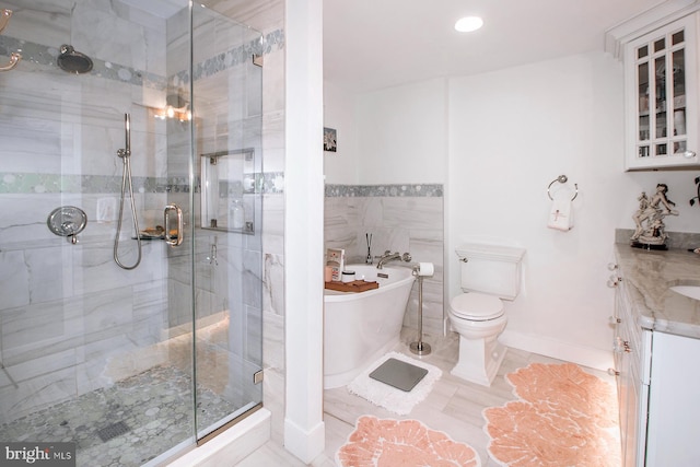 full bathroom featuring tile patterned floors, vanity, shower with separate bathtub, and toilet