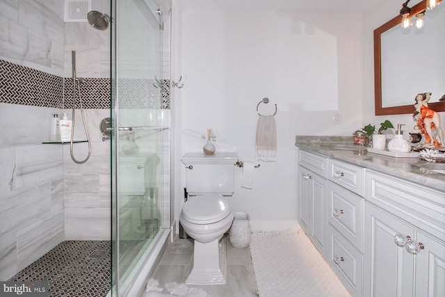 bathroom with vanity, toilet, and an enclosed shower