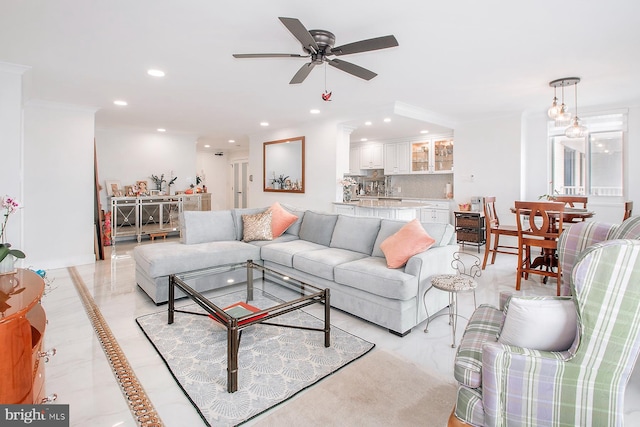 living room featuring ornamental molding and ceiling fan