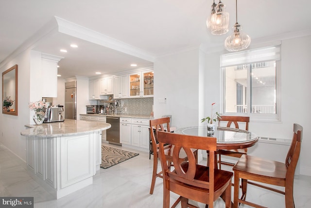 dining room with sink and crown molding