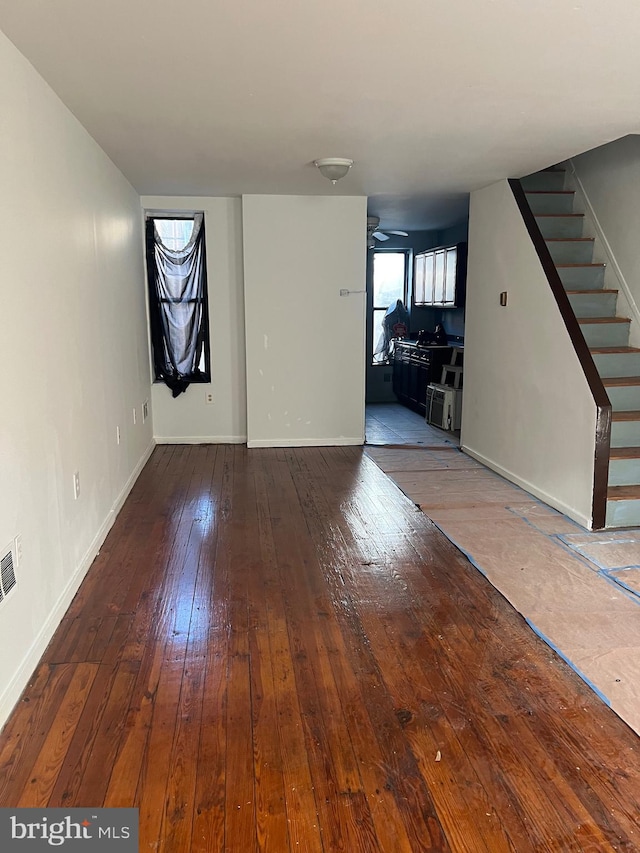 unfurnished living room featuring hardwood / wood-style floors and ceiling fan