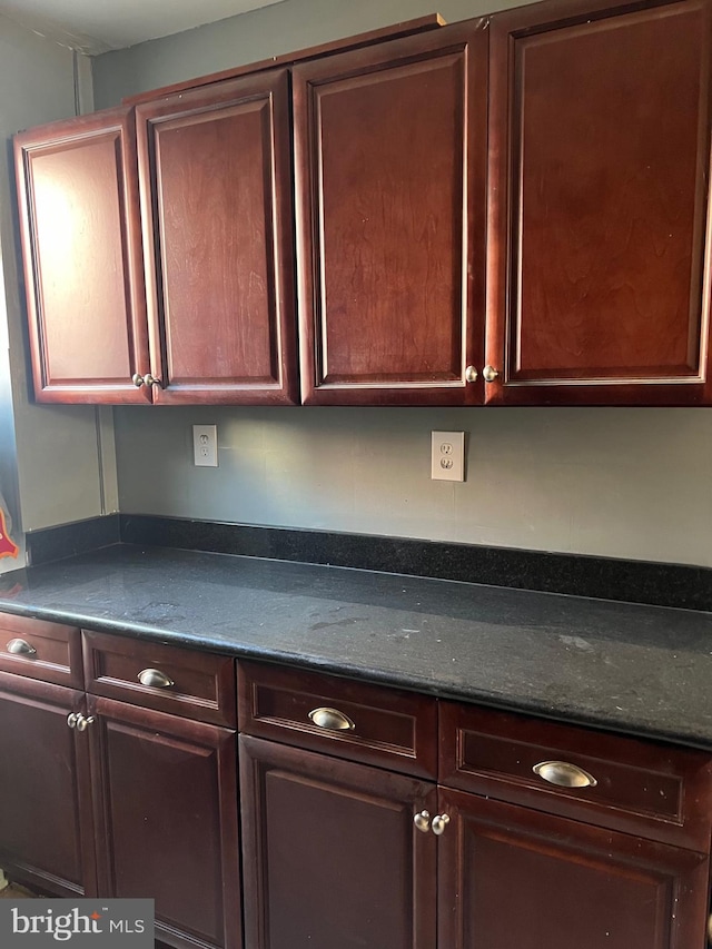 kitchen featuring dark stone counters