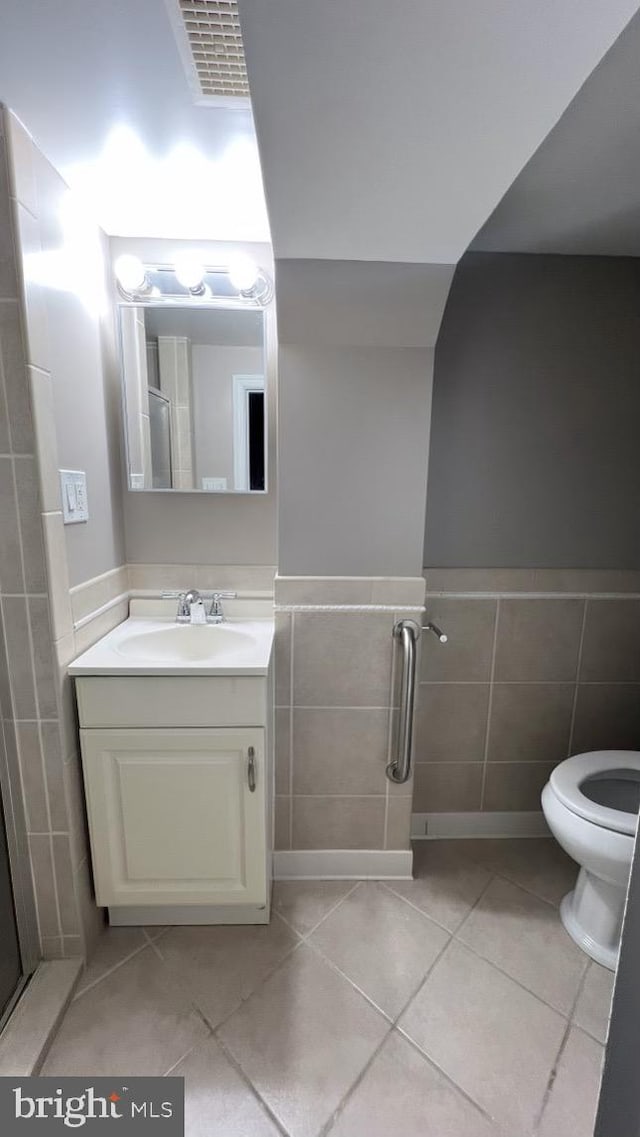 bathroom with vanity, tile walls, and tile patterned flooring