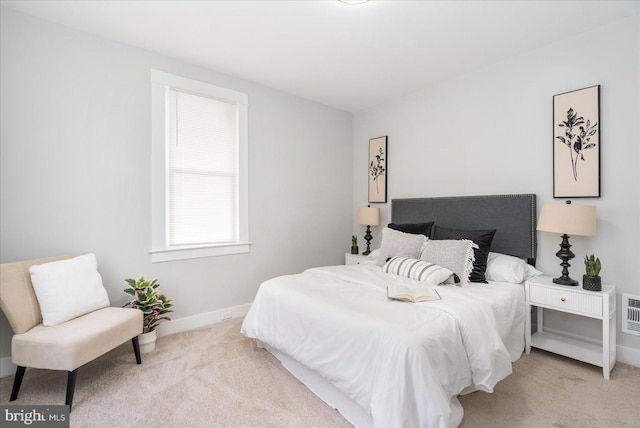 bedroom featuring light carpet