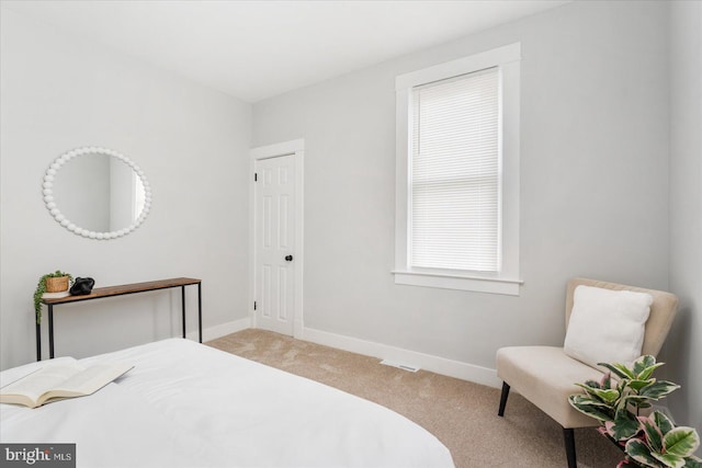 bedroom featuring light colored carpet