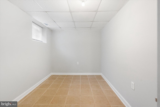 tiled spare room with a paneled ceiling