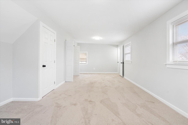 unfurnished room featuring light colored carpet