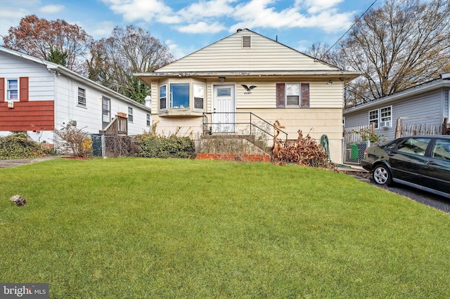 bungalow-style house with a front lawn