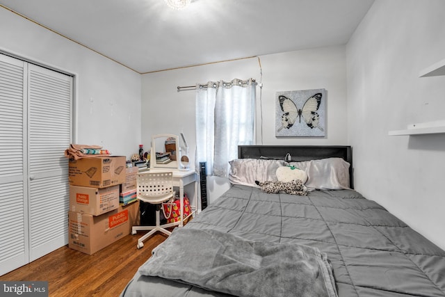 bedroom with wood-type flooring and a closet