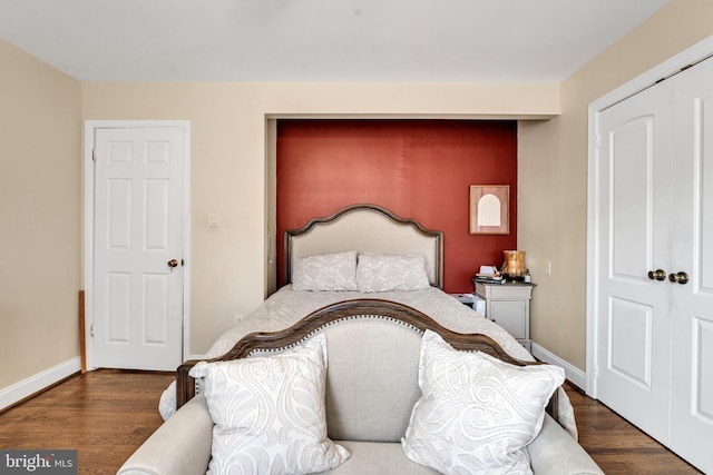 bedroom featuring a closet and dark hardwood / wood-style flooring