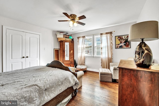 bedroom featuring ceiling fan, wood-type flooring, and a closet