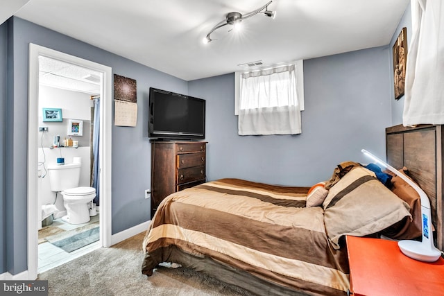 bedroom featuring carpet flooring and ensuite bathroom