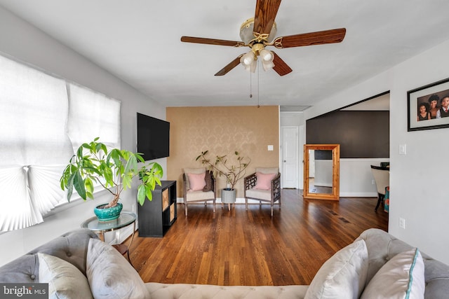 living room with ceiling fan and dark wood-type flooring