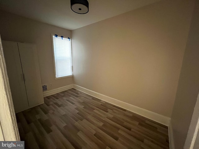 unfurnished room featuring dark hardwood / wood-style floors