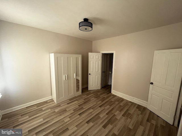 unfurnished bedroom featuring dark hardwood / wood-style floors