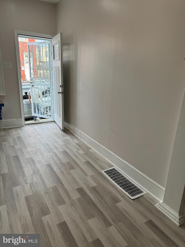 empty room with light hardwood / wood-style flooring