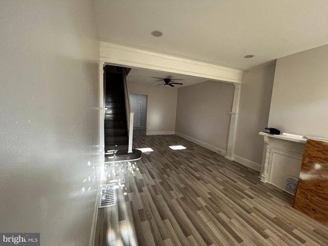 unfurnished living room featuring hardwood / wood-style flooring and ceiling fan