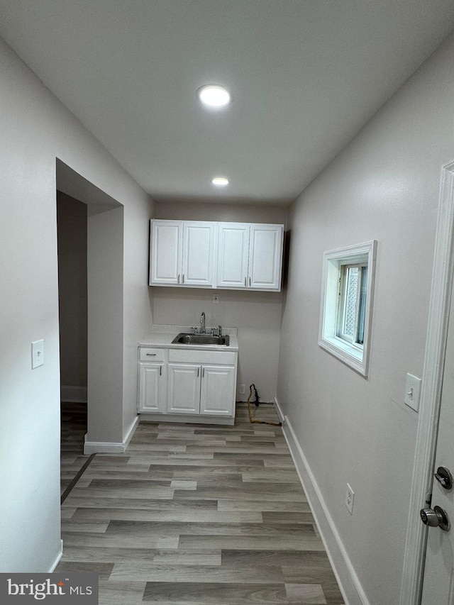 washroom with sink and light wood-type flooring