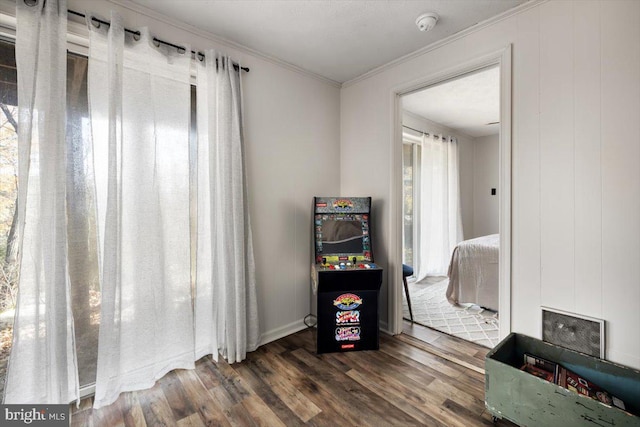 bedroom featuring dark hardwood / wood-style flooring and ornamental molding