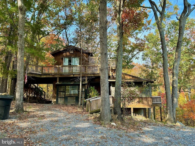 back of house with a wooden deck