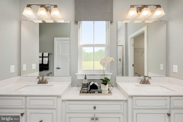 bathroom featuring vanity and an enclosed shower