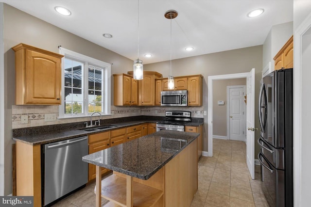 kitchen with stainless steel appliances, hanging light fixtures, sink, light tile patterned floors, and a kitchen island