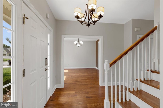 entrance foyer featuring a notable chandelier and dark hardwood / wood-style floors