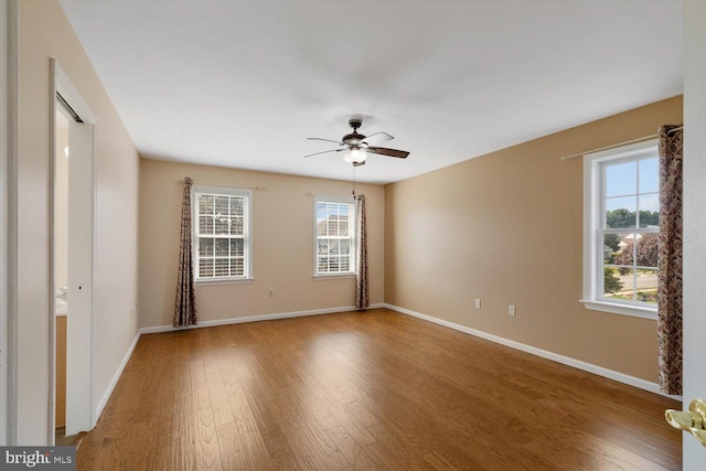 empty room with hardwood / wood-style flooring and ceiling fan