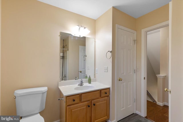 bathroom featuring hardwood / wood-style floors, vanity, and toilet