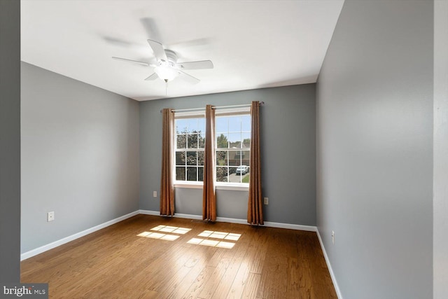 empty room featuring wood-type flooring and ceiling fan