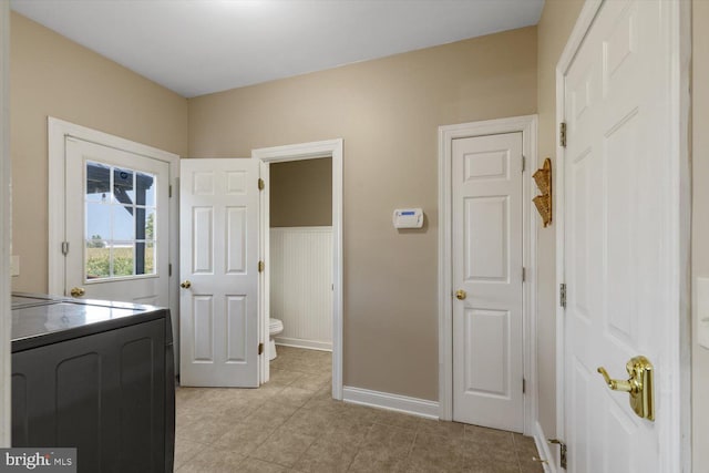 interior space with light tile patterned flooring and independent washer and dryer