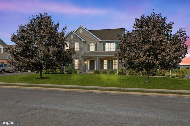 view of front of home with a lawn and covered porch