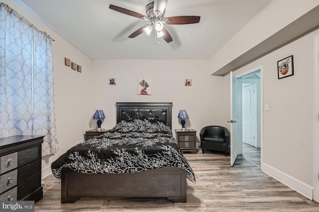 bedroom featuring hardwood / wood-style flooring and ceiling fan