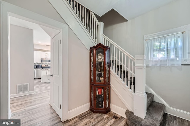 stairway featuring hardwood / wood-style floors