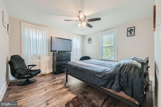 bedroom with hardwood / wood-style flooring and ceiling fan