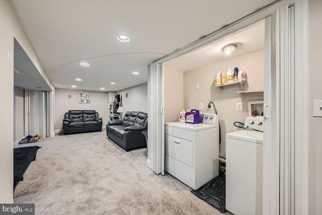 laundry room featuring light colored carpet and washer and dryer