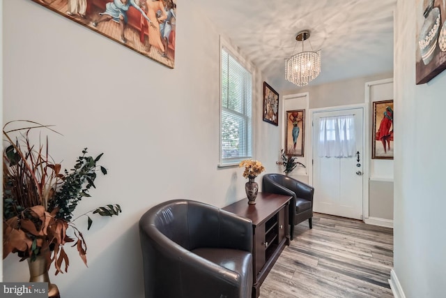 entryway with light hardwood / wood-style flooring and a chandelier