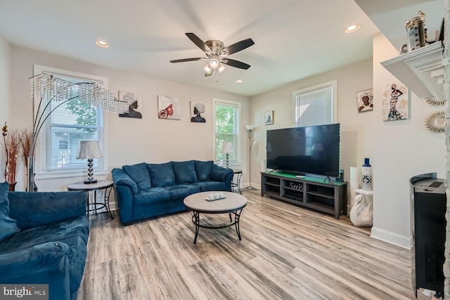 living room with hardwood / wood-style flooring and ceiling fan