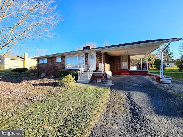 ranch-style house featuring a carport