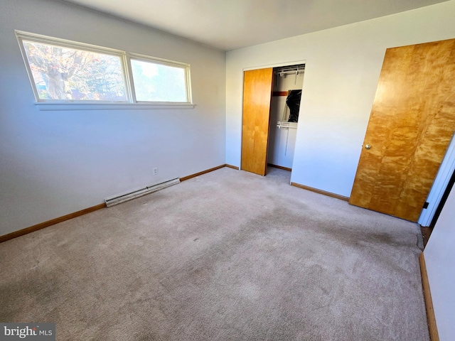 unfurnished bedroom with a baseboard radiator, light colored carpet, and a closet