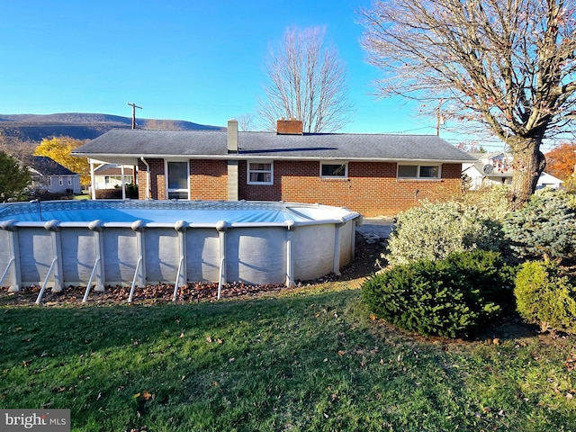 rear view of house with a yard